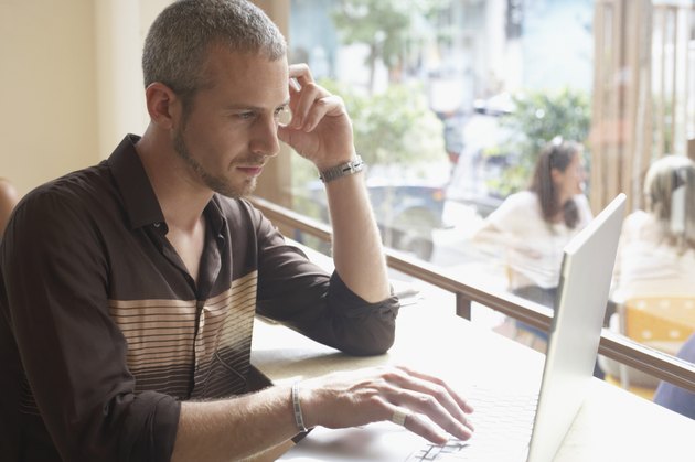 Close-up of a young man using a laptop