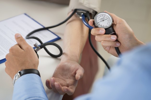 Doctor Measures Pressure In The Patient