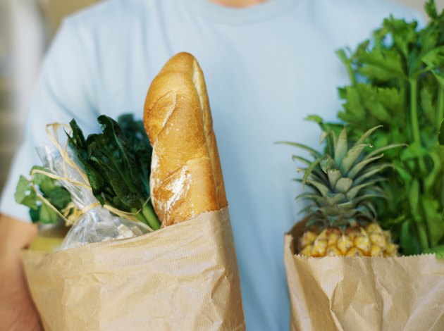 mid section view of a person holding shopping bags