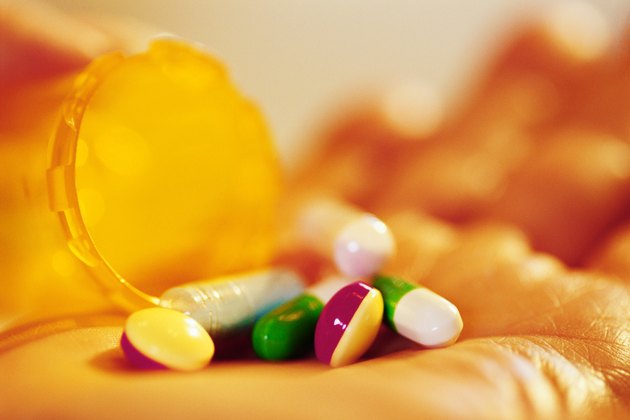 Bottle of pills in hand