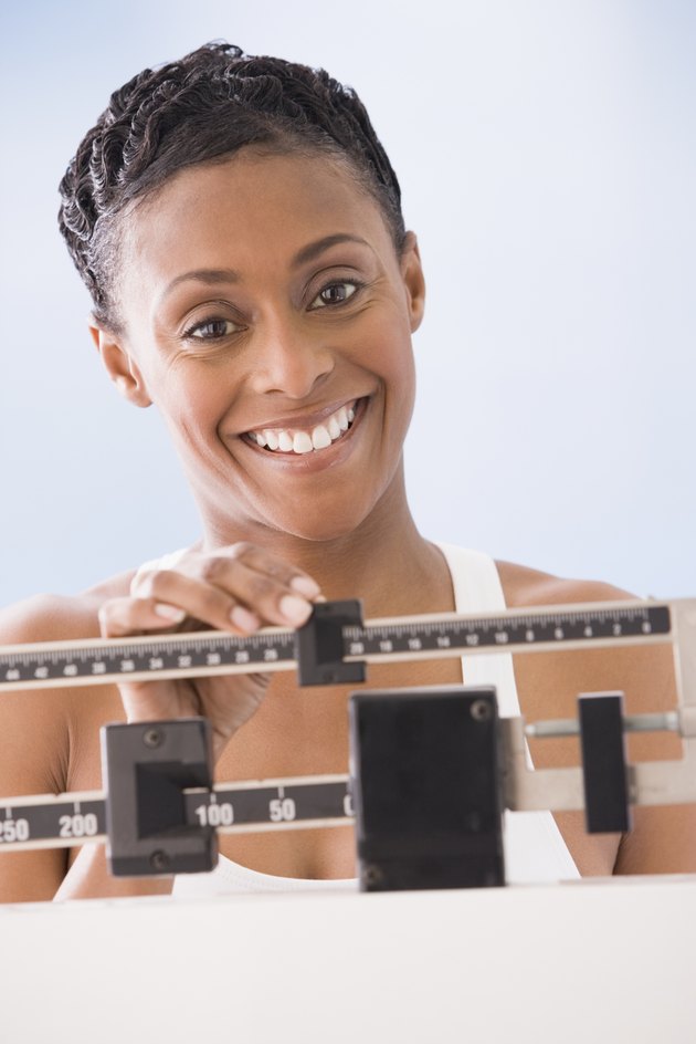African American woman weighing self