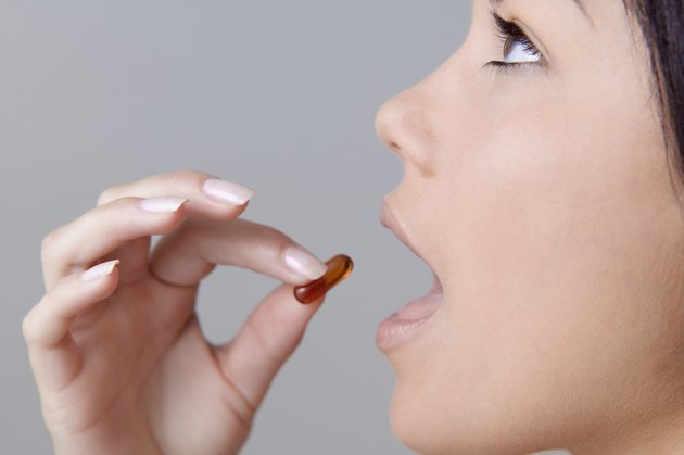 Young woman taking a pill