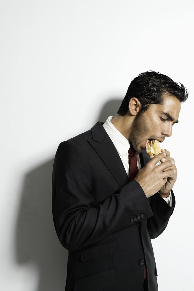Businessman eating sandwich