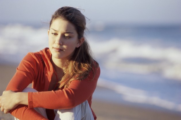 Teenage girl sitting at the beach