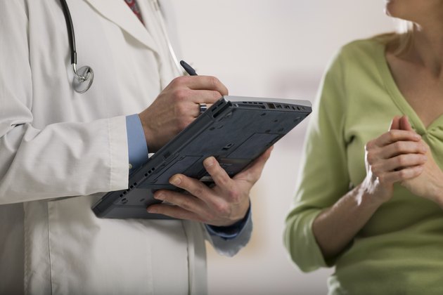 Doctor writing on tablet pc