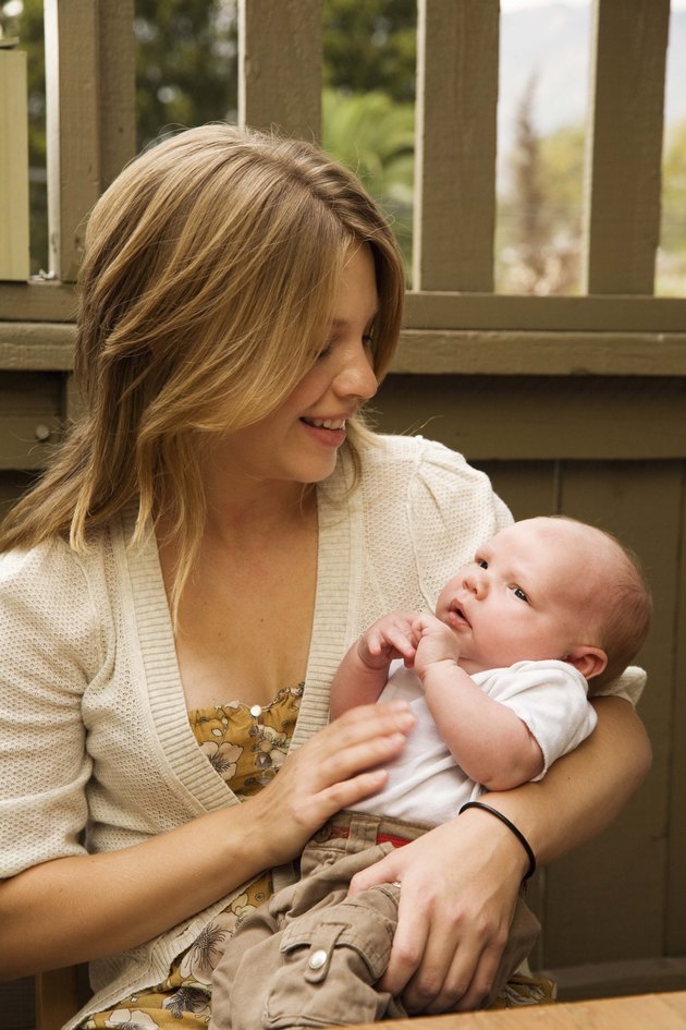 Mother cradling baby