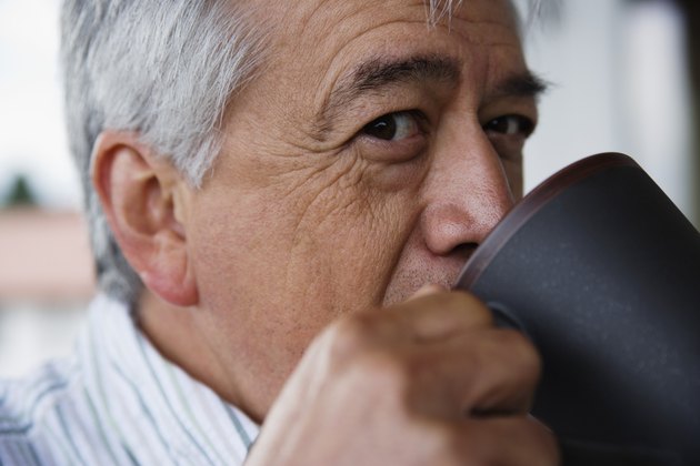 Close up profile of elderly man drinking coffee