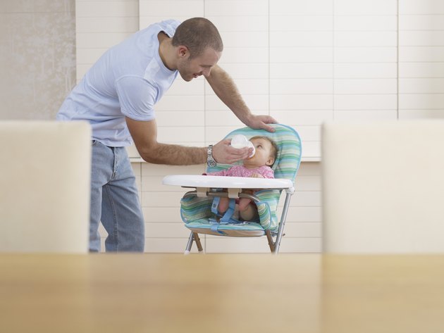 Man feeding baby