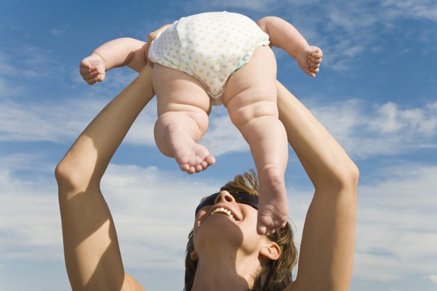 Mother holding baby up in air