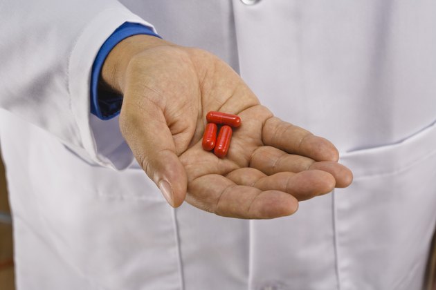 Doctor holding pills
