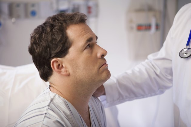 Doctor talking with patient in hospital room