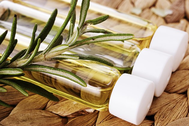 Organic oil with a sprig of rosemary closeup