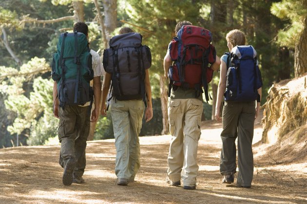 Couples backpacking in woods
