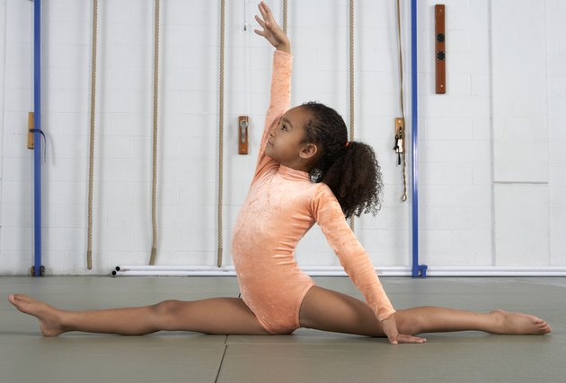 Young girl gymnast practicing her floor exercises