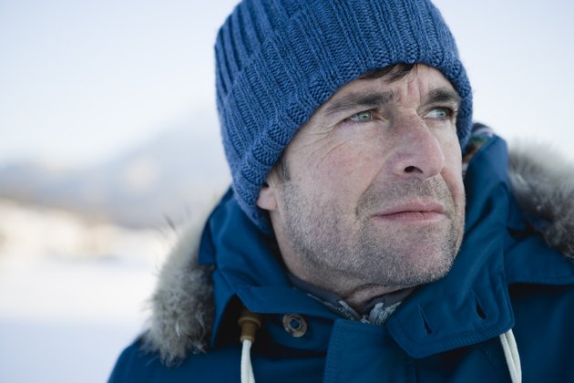 Mature man in blue hat, looking away