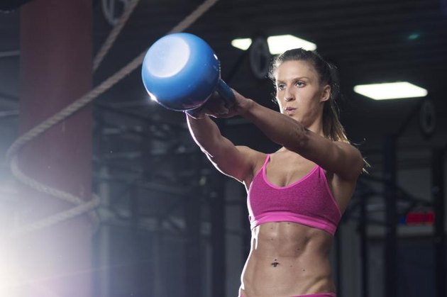 Portrait of young girl training with weights