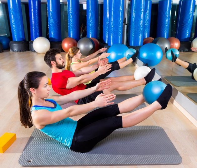 Pilates softball the teaser group exercise at fitness gym