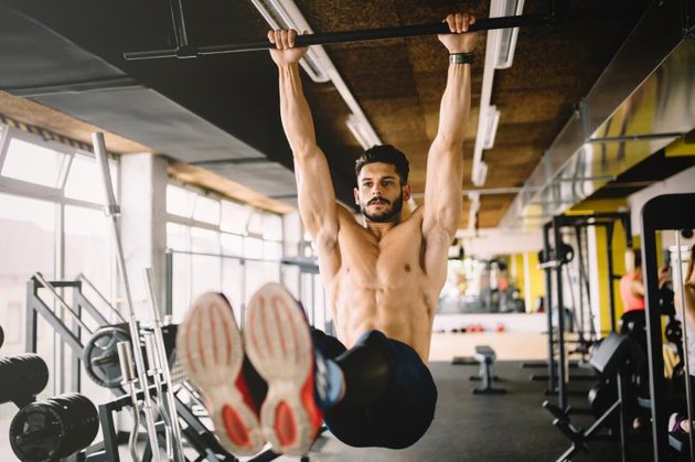 Muscular man working on six pack in gym