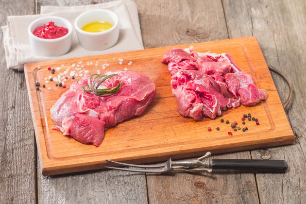 Raw meat on wooden cutting board