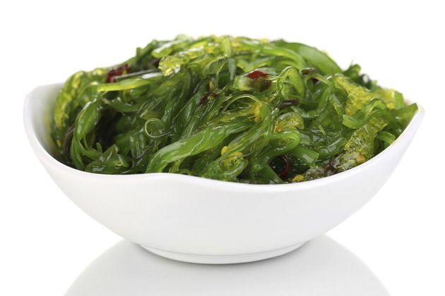 Sea kale in bowl close-up isolated on white