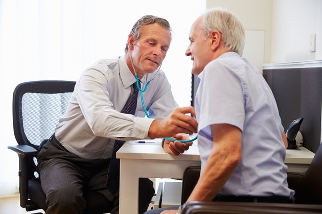 Senior Patient Having Medical Exam With Doctor In Office