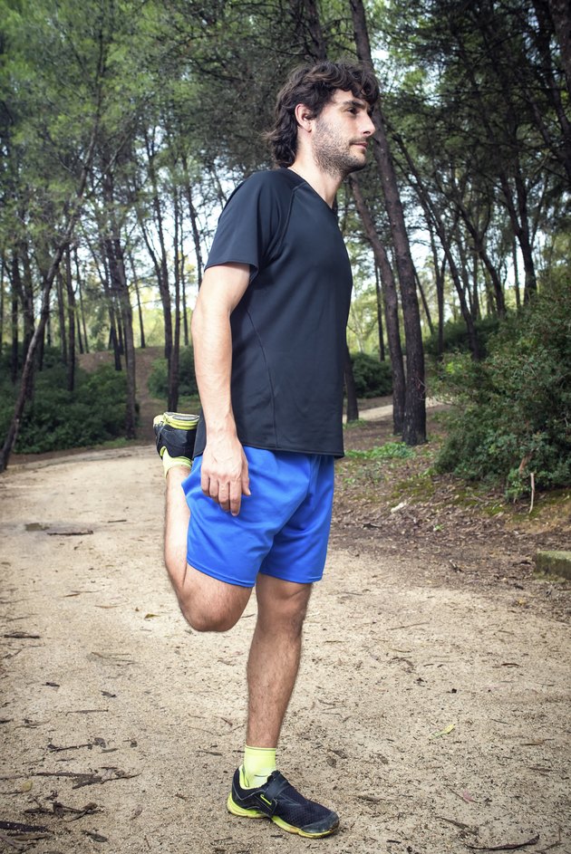 Male athlete doing stretching leg