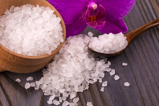 White bath salt in a wooden bowl