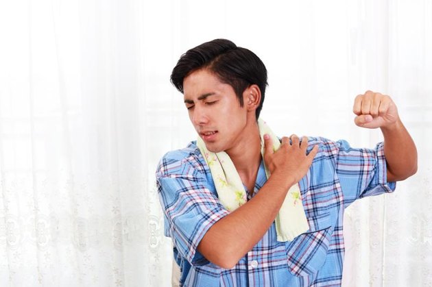 Asian man having a shoulder pain