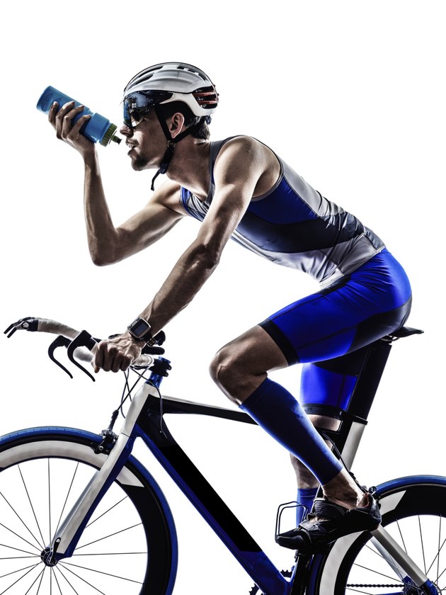 man triathlon iron man athlete cyclist bicycling drinking