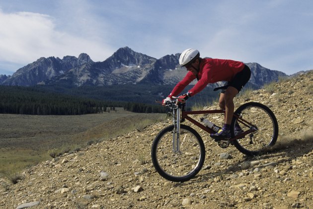 Mountain biker riding downhill in mountain area