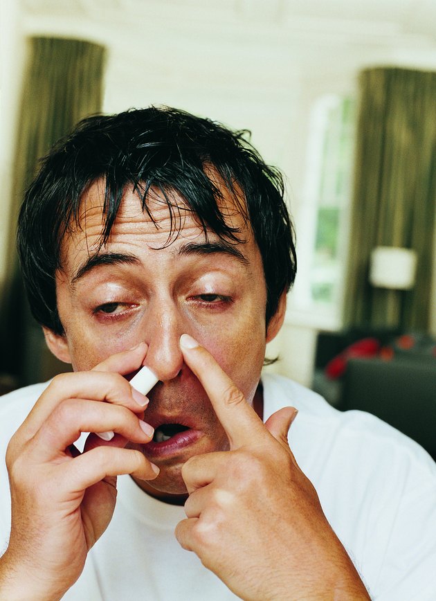 Man Using a Nasal Inhaler