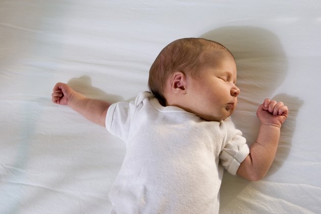 Newborn baby sleeping on the bed