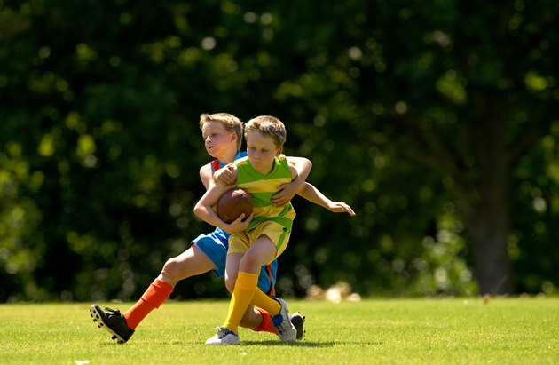 Young football player tackles opposition