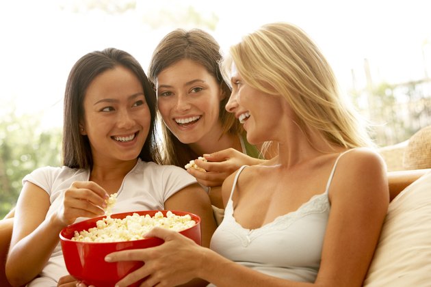 Friends eating bowl of popcorn