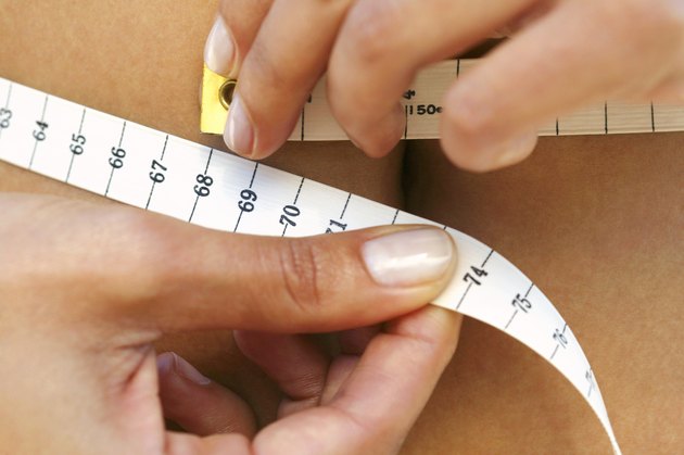 Woman measuring waistline