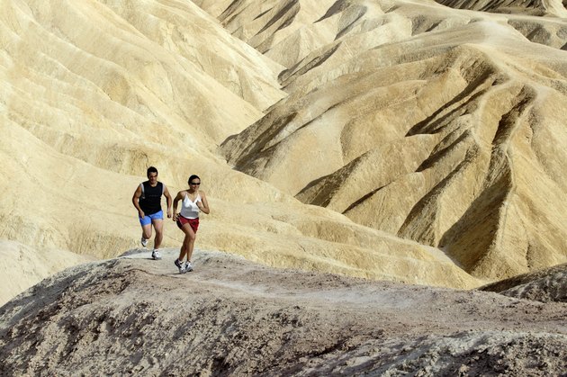 Man and woman running in desert