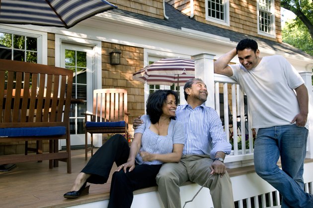 Parents and son talking on back porch