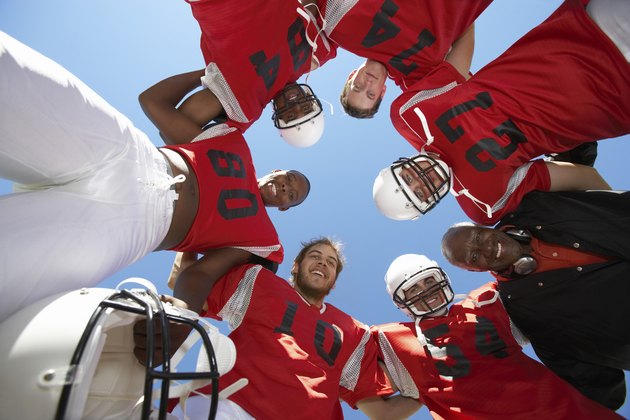 Football Players and Coach in Huddle