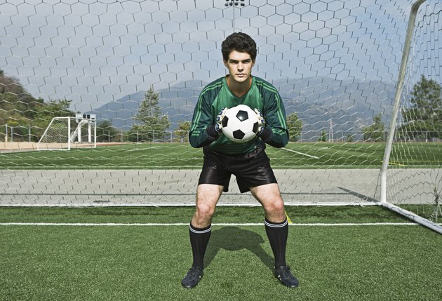 Soccer goalie holding ball