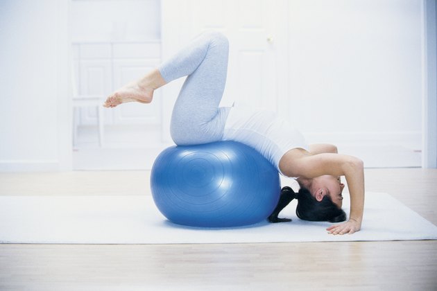 Woman stretching on yoga ball
