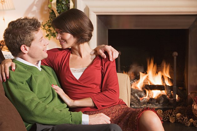 Couple resting by fireplace