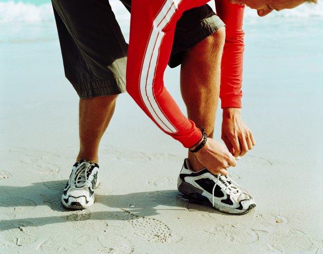 young tying his shoe laces