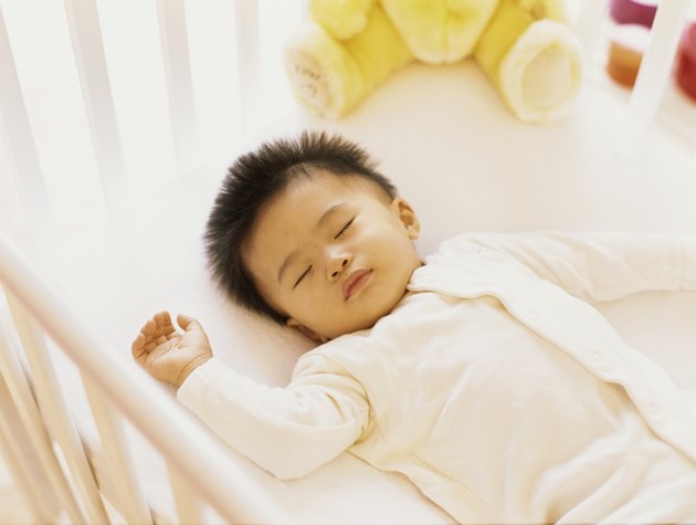 high angle view of a baby boy sleeping in a crib