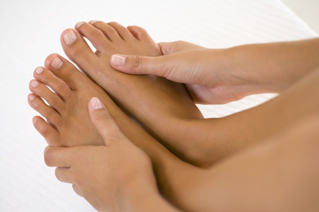 Hands massaging bare feet