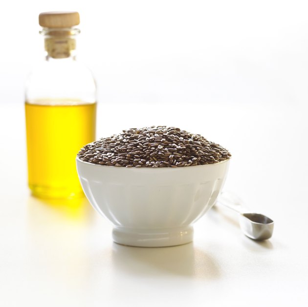 Flax seed and olive oil with measuring spoon