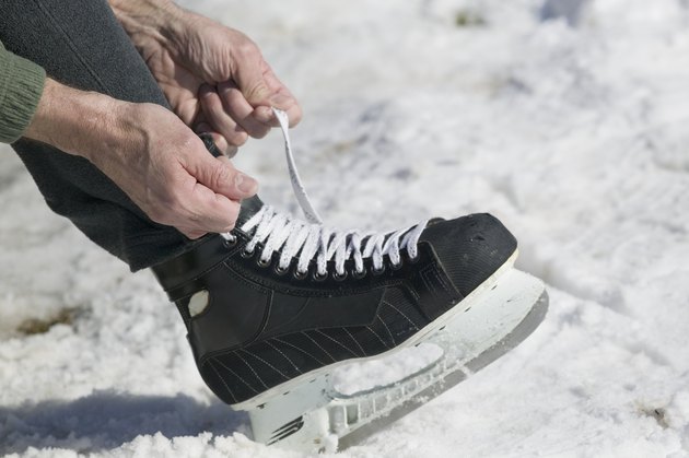Close up of man lacing ice skate