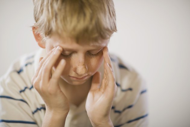 Boy with hands on head