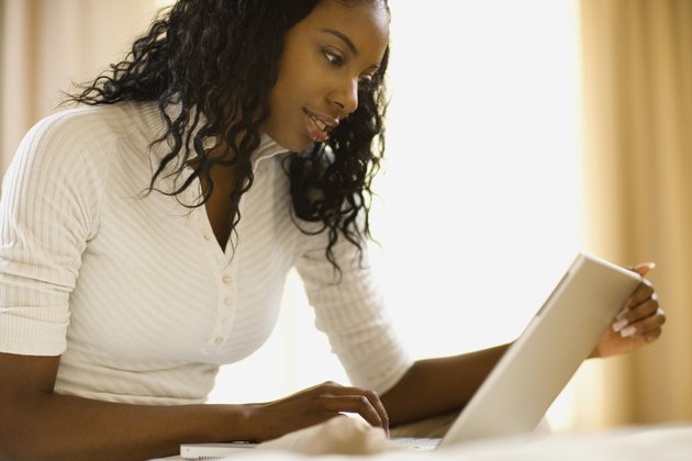 Woman working at home with laptop computer