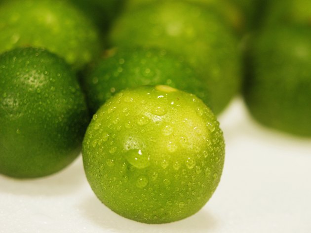 Close-up of water drops on limes