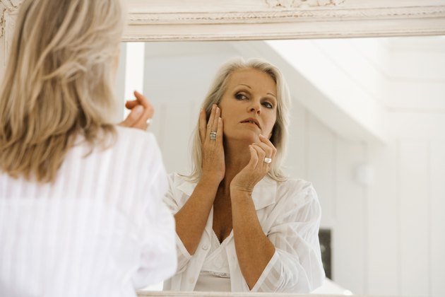 Woman examining complexion